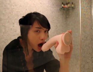 Attractive asian woman toying with fuck stick in bathroom
